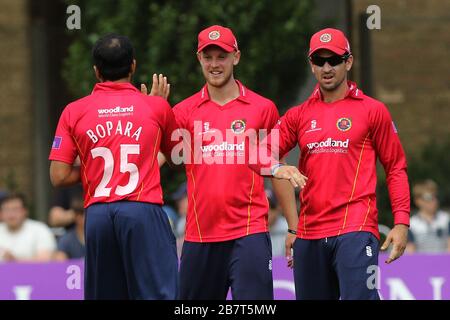 Ravi Bopara of Essex Eagles (L) is congratulated by his team mates after taking the wicket of Sam Robson Stock Photo