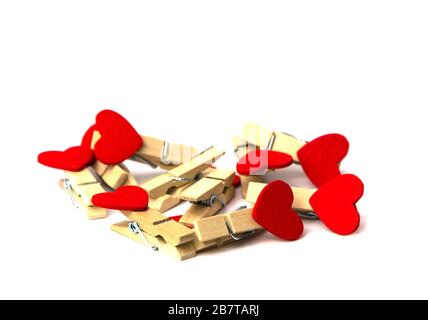 a bunch of clothespins with hearts on a white background Stock Photo