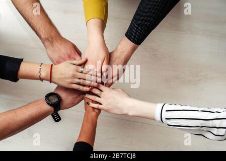Group of Diverse Multiethnic People Teamwork Concept. Teamwork Togetherness Collaboration Concept. Hands of office workers in a circle. Stock Photo