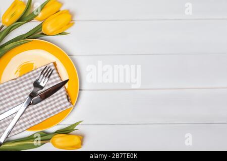 Festive table with yellow tulips. Stock Photo