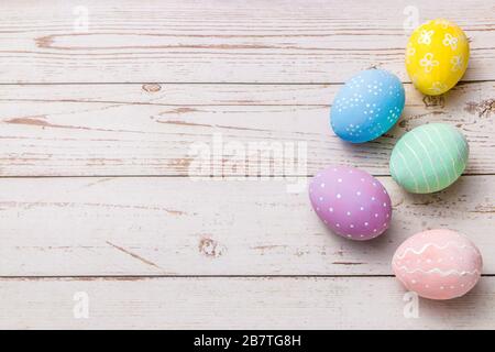 easter background with hand painted pastel colors eggs on light colored wooden table Stock Photo