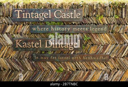 Entrance signs on a traditional Cornish slate wall at Tintagel Castle, linked to the legend of King Arthur, Tintagel, Cornwall, UK. Stock Photo