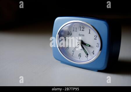 retro style quartz alarm clock on table top Stock Photo