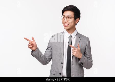 Waist-up portrait of successful, professional young asian man starting his career in IT company, presenting his project on meeting, looking and Stock Photo