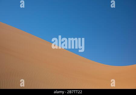 Abstract landscape with desert dunes on a sunny day. Liwa desert, Abu Dhabi, United Arab Emirates. Stock Photo