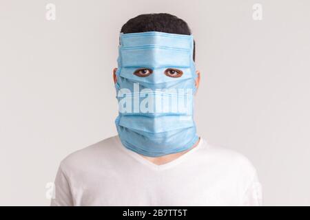 Protection against contagious disease, coronavirus. Man wearing hygienic mask to prevent infection, airborne respiratory illness such as flu, 2019-nCo Stock Photo