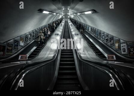 A long escalator in Green Park Station on the Piccadilly Line on the London Underground. Stock Photo