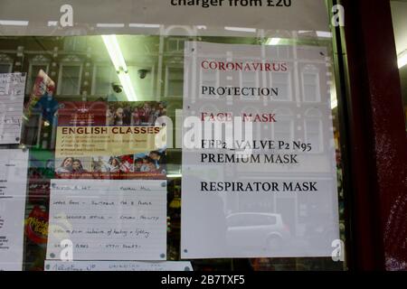 a newsagent in london advertising protective masks for sale against corona virus england UK Stock Photo