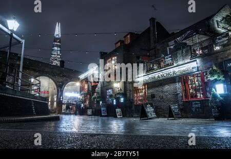 Night view of The Anchor Bankside pub on the South Bank of the Thames in London, The Shard is visible in the background. Stock Photo