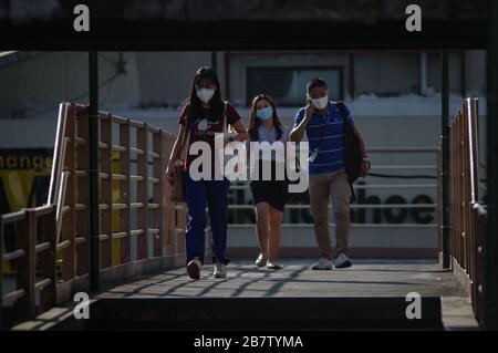 Philippines. 18th Mar, 2020. Pedestrians walk their way to work on a footbridge in Mandaluyong City on Wednesday, 18 March 2020. Luzon Island is currently under enhanced community quarantine suspending all transportation and works. On Tuesday, 17 March, President Rodrigo Duterte has placed the entire nation under state of calamity in order for the government to respond properly to the rising cases of COVID-19 in the country. (Photo by Larry Monserate Piojo/Sipa USA) Credit: Sipa USA/Alamy Live News Stock Photo