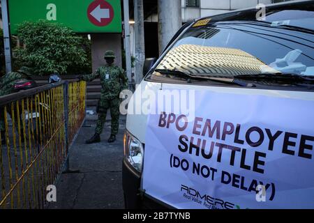 Some private vans carrying BPO employees working in Mandaluyong City arrive at a barricade in Sultan St. near Shaw Blvd. on Wednesday, 18 March 2020. Mandaluyong City Police has set up barricades in all entry points of the city to limit the entry of people while Luzon island is under enhanced community quarantine. President Rodrigo Duterte has placed the entire nation under state of calamity on Tuesday, March 17 in order for the government to respond properly to the rising cases of coronavirus (Covid-19) in the country. (Photo by Larry Monserate Piojo/Sipa USA) Stock Photo