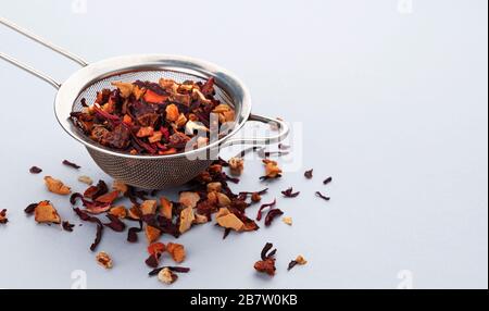 Tea strainer with tea leaves and fruits and berries Stock Photo