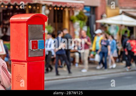 An old red fire call box in NYC. Typically installed on street corners, used to notify the fire department of a fire before general availability of te Stock Photo