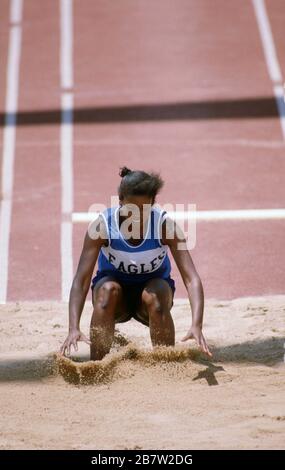 Austin, Texas USA: High school athlete lands in sand pit during girls long jump competition at the state championship track and field meet.  ©Bob Daemmrich Stock Photo