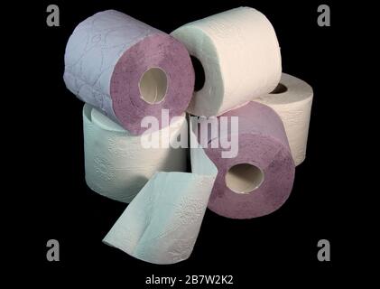 Three toilet paper rolls on a black background Stock Photo