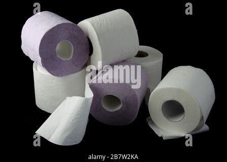 Three toilet paper rolls on a black background Stock Photo