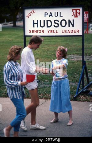 College Station Texas USA: Young woman running for student government office hands out campaign literature to fellow college students on campus at Texas A&M University.  ©Bob Daemmrich Stock Photo