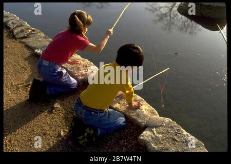 Austin Texas USA: Six-year-old boy and girl fishing in Barton Creek with bamboo  fishing poles. MR ©Bob Daemmrich Stock Photo - Alamy