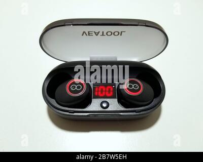 Wilmington, Delaware, U.S.A - March 17, 2020 - The Bluetooth wireless earbuds by Veatool inside a charging case Stock Photo