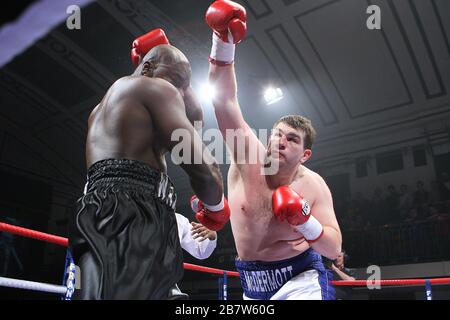 John McDermott (white/blue shorts) defeats Larry Olubamiwo in a Heavyweight boxing contest for the Southern Area Title at York Hall, Bethnal Green, Lo Stock Photo