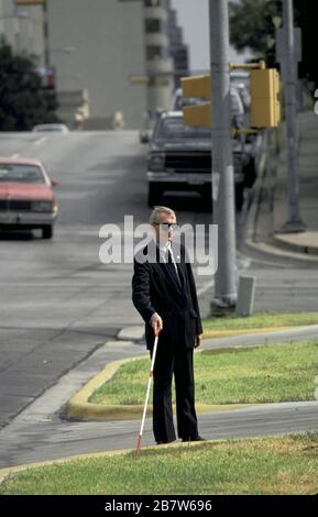 Austin, Texas USA: Visually impaired man using cane to navigate while walking downtown. ©Bob Daemmrich Stock Photo