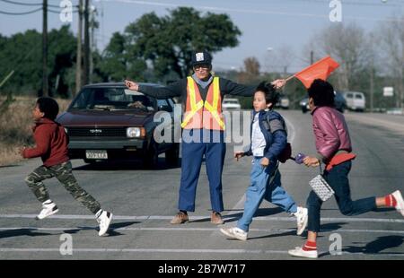 Austin, Texas USA:  Crossing guard at elementary school intersection directs students to cross street safely. . ©Bob Daemmrich Stock Photo