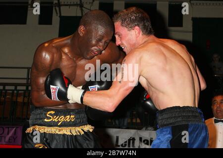 Ryan Toms (blue shorts) draws with Nathan Weise in a Light-Middleweight boxing contest at York Hall, Bethnal Green, promoted by Miranda Carter / Left Stock Photo