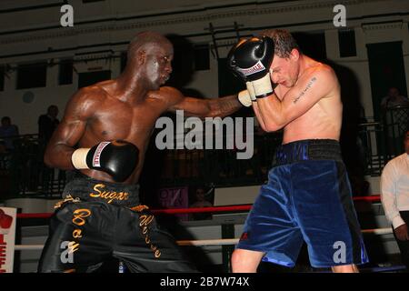 Ryan Toms (blue shorts) draws with Nathan Weise in a Light-Middleweight boxing contest at York Hall, Bethnal Green, promoted by Miranda Carter / Left Stock Photo