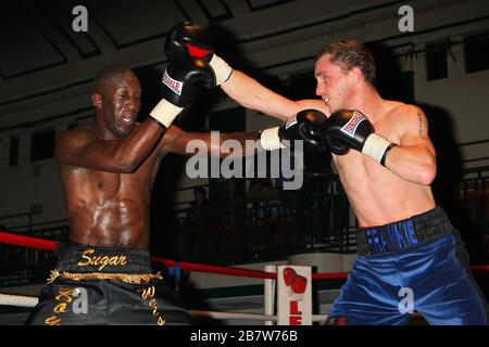 Ryan Toms (blue shorts) draws with Nathan Weise in a Light-Middleweight boxing contest at York Hall, Bethnal Green, promoted by Miranda Carter / Left Stock Photo