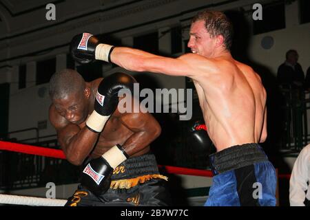 Ryan Toms (blue shorts) draws with Nathan Weise in a Light-Middleweight boxing contest at York Hall, Bethnal Green, promoted by Miranda Carter / Left Stock Photo