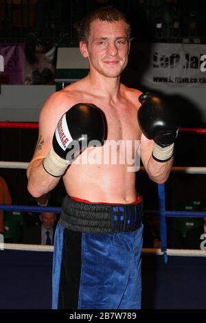 Ryan Toms (blue shorts) draws with Nathan Weise in a Light-Middleweight boxing contest at York Hall, Bethnal Green, promoted by Miranda Carter / Left Stock Photo