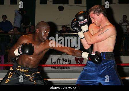 Ryan Toms (blue shorts) draws with Nathan Weise in a Light-Middleweight boxing contest at York Hall, Bethnal Green, promoted by Miranda Carter / Left Stock Photo