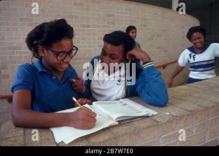 Austin Texas USA:  Black junior high students studying in the hallway during lunch period. ©Bob Daemmrich Stock Photo