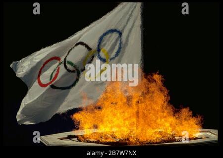 Seoul South Korea 1988: Olympic flag and flame of Olympic cauldron during Summer Games opening ceremonies.  ©Bob Daemmrich Stock Photo