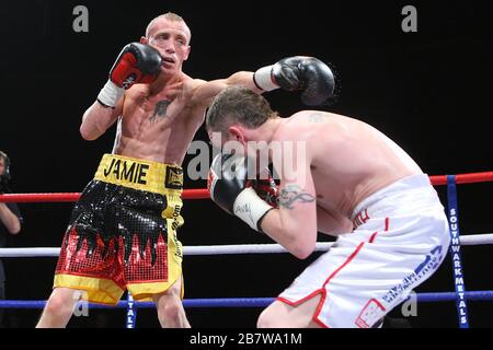 Jason Booth (white shorts) defeats Jamie Arthur in a Super-Middleweight contest for the British and Commonwealth Titles at the Brentwood Centre, promo Stock Photo