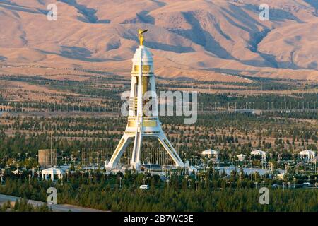 Neutrality Monument in Ashgabat, Turkmenistan built with white marble and gold details. Celebrate the country's neutrality in the United Nations. Stock Photo