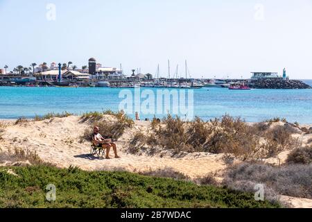 Looking across to the harbour at Caleta de Fuste on the east coast of the Canary Island of Fuerteventura Stock Photo