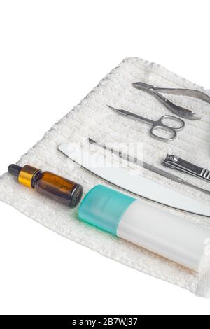 manicure tools set hand nail care on fluffy white towel in spa salon, side view, equipment for manicure, copy space Stock Photo
