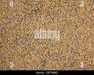 Gravel texture. Background golden gravel surface. Stock Photo