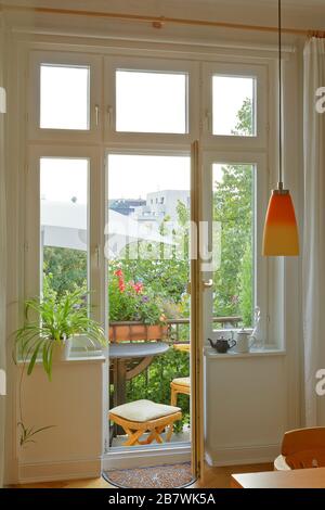Balcony of an historic townhouse in summer, seen through the windows and door of the living room. Stock Photo
