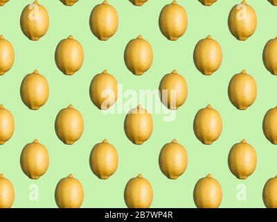 Seamless pattern of whole lemons on mint green background. Flat lay, top view. Vitamin C fruit Stock Photo