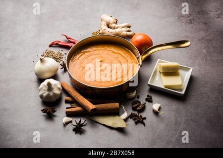 North Indian basic Curry for paneer butter masala or chicken makhanwala recipe shown with ingredients, served in a bowl. selective focus Stock Photo