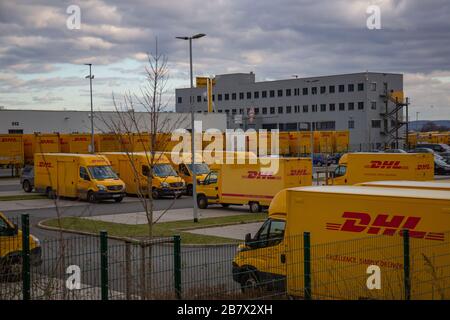 Neuwied, Germany - March 07, 2020: DHL delivery vans in front of a DHL depot and office building. DHL is a global market leader in logistics Stock Photo