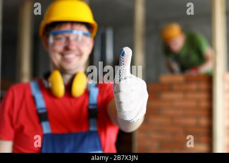 Happy smiling male worker showing thumb up gesture Stock Photo