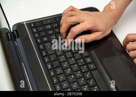 Work at home with laptop woman writing blog. Female hands on the keyboard, button enter Stock Photo