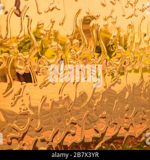 Curved abstract metallic background. Gold abstract drops. texture Stock Photo