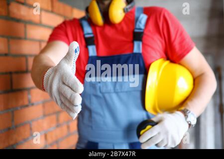 Worker at construction site offering hand to shake Stock Photo