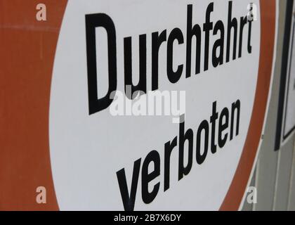 Side view on isolated red and white sign passage forbidden (german words: Durchfahrt verboten) - Germany Stock Photo
