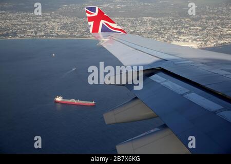 Boeing 747-400 (744) in flight view of Barbados Through Aeroplane Window - Plane coming into Land Stock Photo