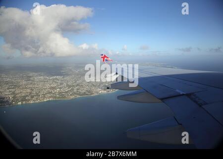 Boeing 747-400 (744) in flight view of Barbados Through Aeroplane Window - Plane coming into Land Stock Photo